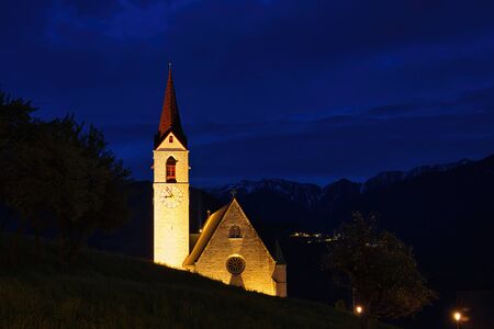 The parish church Maria Himmelfahrt in Feldthurns, South Tyrol during the "blue hour"の写真素材