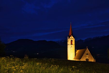 The parish church Maria Himmelfahrt in Feldthurns, South Tyrol during the "blue hour"の写真素材