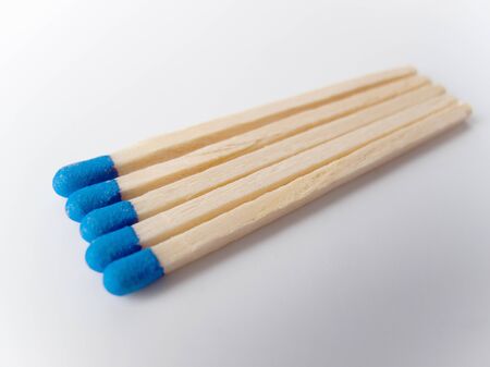 Five wooden matches with blue topの写真素材