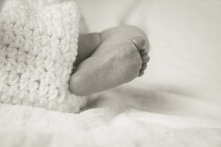 Foot of a newborn Baby in Crochet Blanketの写真素材