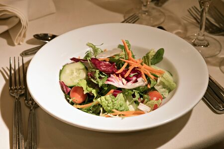 Fresh Plate of Salad on a Table with Flatwareの写真素材