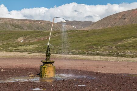 Shower on a natural fountain in Icelandの写真素材