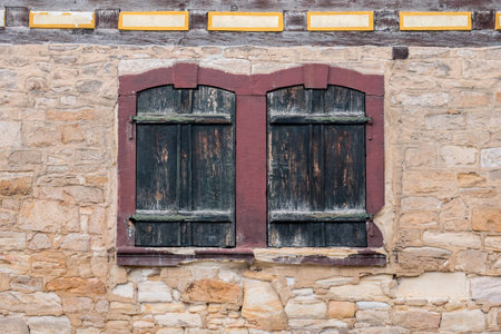 Windows with closed shutters in a medievil sandstone wallの写真素材