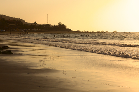 MANCORA, PERU - SEPTEMBER 15, 2013: Unidentified people on the beach and in the water in the light of the setting sun on September 15, 2013 in Mancora, Peru. Mancora is a popular beach town in Northern Peru.  のeditorial素材