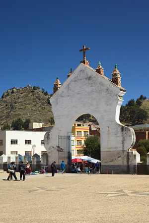 COPACABANA, BOLIVIA - OCTOBER 18, 2014: The gate of the Basilica of Our Lady of Copacabana seen from the courtyard of the church with view of the Mount Calvario in the back on October 18, 2014 in Copacabana, Boliviaのeditorial素材