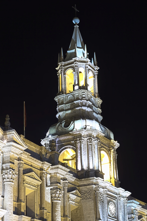 The steeple of the Basilica Cathedral on Plaza de Armas in Arequipa in Southern Peru photographed at night. の写真素材