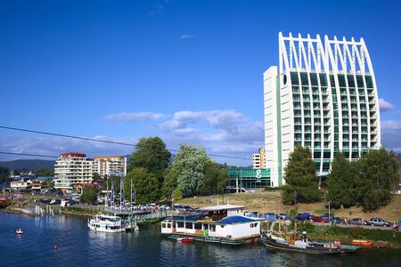 VALDIVIA, CHILE - FEBRUARY 3, 2016: Hotel Dreams Pedro de Valdivia and the riverside promenade in the city center photographed from Pedro de Valdivia bridge on February 3, 2016 in Valdivia, Chile. Valdivia is a popular tourist destination in Chile.のeditorial素材