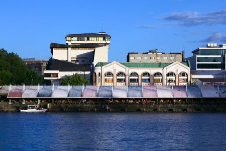 VALDIVIA, CHILE - FEBRUARY 3, 2016: Feria Fluvial (riverside market selling fish, fruit, vegetable) and behind it the Municipal Market housing handicraft shops and restaurants, photographed on February 3, 2016 in Valdivia, Chile. Valdivia is a popular touのeditorial素材