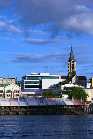 VALDIVIA, CHILE - FEBRUARY 3, 2016: View onto the Feria Fluvial (riverside market) along Arturo Prat avenue and in the back the steeple of the cathedral in the city center on February 3, 2016 in Valdivia, Chile. Valdivia is a popular tourist destination iのeditorial素材