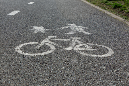 Bicycle and pedestrians road sign on asphalt, white.の写真素材