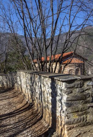 Shadows of trees near the monastery stone wall. Bachkovo.