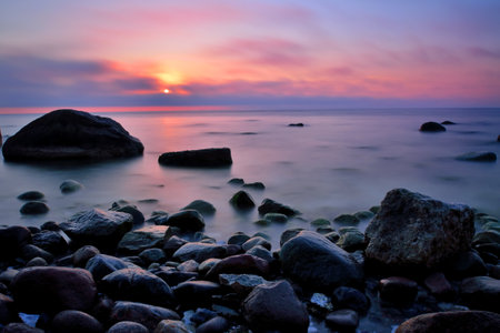 beautiful sunrise sunset at kap arkona baltic sea stones at coastline