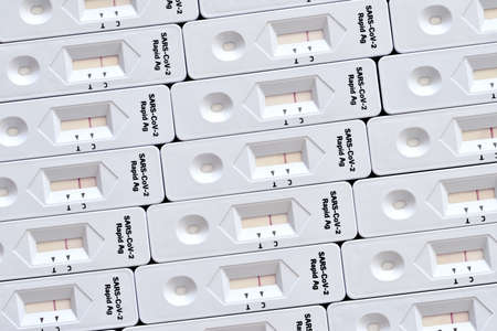 Rapid antigen test kit mosaic surface white macro close-up detail made from many test kitsの写真素材
