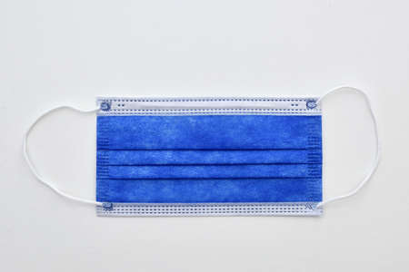 virus disease protective surgical face mask blue mask white laboratory surface isolated objectの写真素材
