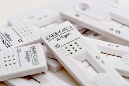 Close-up of  virus rapid antigen test negative outcome bunch of test kits laying on laboratory surfaceの写真素材