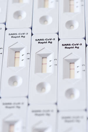 Rapid antigen test kit mosaic surface white macro close-up detail horizontal image