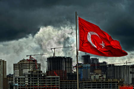 turkey turkish flag waving in front of construction site in istanbul dense population no nature dust clouds no sunの写真素材