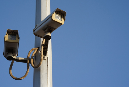 Security camera on blue sky backgroundの写真素材