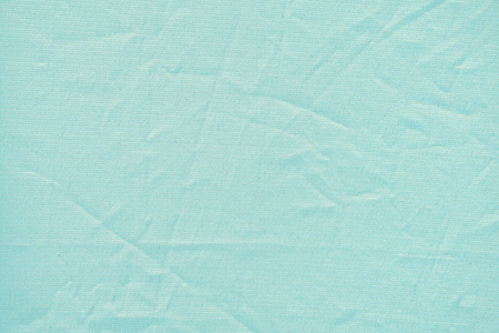Turquoise crumpled texture of dense fabricの写真素材
