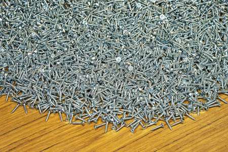 Small chrome screws backgroundの写真素材
