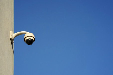 Security camera on blue sky background