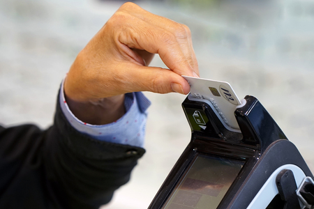 Credit card payment terminal in store. Seller draws up credit card purchases. close-up of a seller...