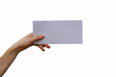 Woman's hand holding a letter. Isolated on white backgroundの写真素材