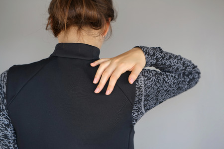 Young woman with pain in her back