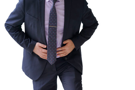 Businessman holding his stomach in pain isolated on a white backgroundの写真素材