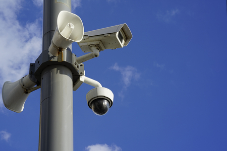 Security camera on blue sky background