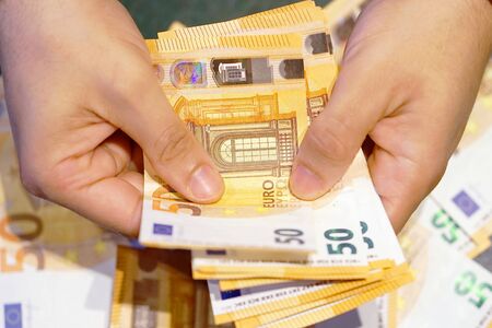 Human hands that consider 50-euro bills. In the hands of a lot of money, 50 denominations of eurosの写真素材