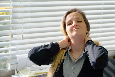 Tired Neck. Close-up office worker Woman Suffering From Neck Pain. Female Feeling Tired, Exhausted, Stressed. Girl Massaging Painful Neck With Hands. Body And Health Care Concept.の写真素材