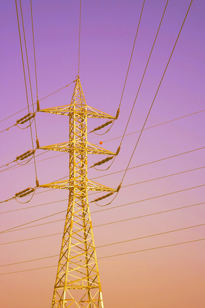 High voltage electric poles on red sky background. Toningの写真素材