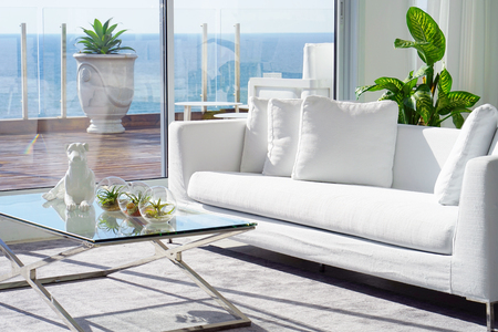 Interior of the living room of the hotel. Beautiful living room with white sofa. White Concept Living Room Interior. Modern bed room interior in Luxury villa. White colours, big windowの写真素材