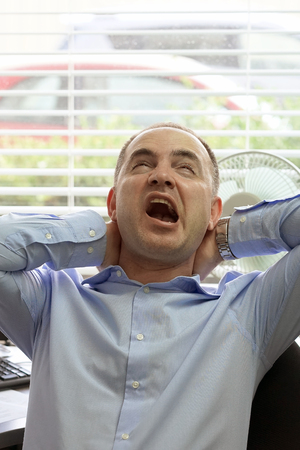 Tired Neck. Office worker man suffering From Neck Pain. male Feeling Tired, Exhausted, Stressed. Men Massaging Painful Neck With Hands. Body And Health Care Concept.の写真素材
