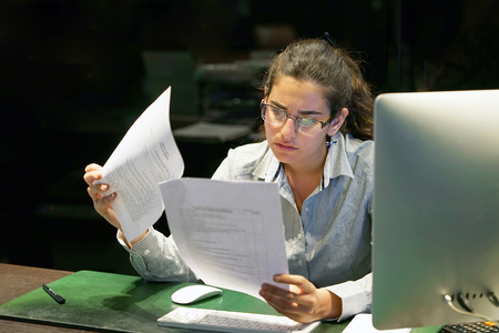A woman-reception hotel worker reading negative news in letter.の写真素材