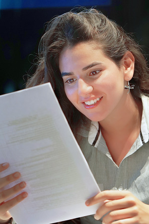 Hotel administrator. A woman-reception worker happy lady, enjoying the good news in writing. An euphoric girl is happy after reading good news in a written letter, approving a loan, raising her job.の写真素材