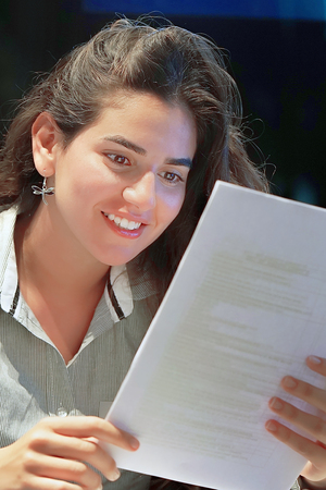 Close-up of an office worker. Happy lady, enjoying the good news in writing. An euphoric girl is happy after reading good news in a written letter, approving a loan, raising her job.の写真素材
