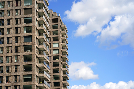 Modern multi-storey building on the sky background Balconies in the building. Modern apartment buildings in new neighborhood. Residential buildingsの写真素材