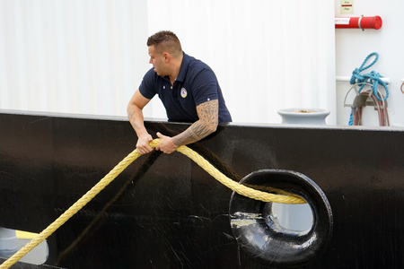 Sailor on a cargo ship tying mooring cable. 7 September 2018. Rotterdam. Netherlands.のeditorial素材