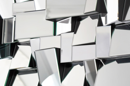 Mirror with foursquare in wall, decoration and reflection. Abstract glass background. Polygonal surface. Close-up. Texture.の写真素材