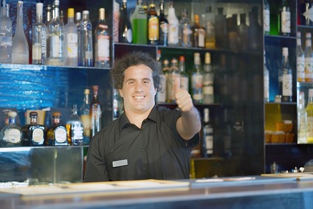 Professional bartender arm show OK in workplace closeup. High level and quality service. The concept of service.の写真素材
