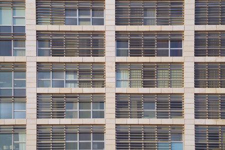Glass grey square Windows of modern city business building skyscraper. Glass balconies in the building. Modern apartment buildings in new neighborhood. Windows of a building, texture.の写真素材