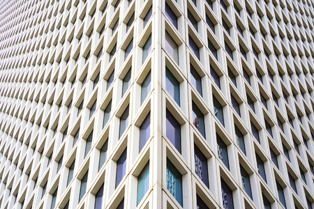 Angle modern business building skyscraper glass and aluminum, white square. Windows of facade. Modern apartment buildings in new neighborhood. Windows of a building, texture.の写真素材