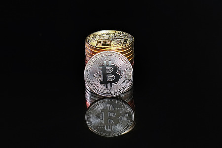 Close-up virtual currency bitcoin on black background. Golden, silver, bronze, bitcoins on black...