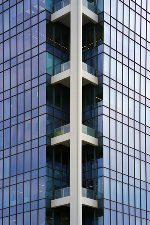 Angle modern business building skyscraper blue glass and aluminum, white square. Windows of facade. Modern apartment buildings in new neighborhood. Windows of a building, texture.の写真素材