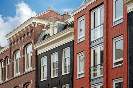 A number of houses in the traditional Dutch architectural style. Triangular roofs with orange tiles. A number of colorful old houses in Europe.の写真素材