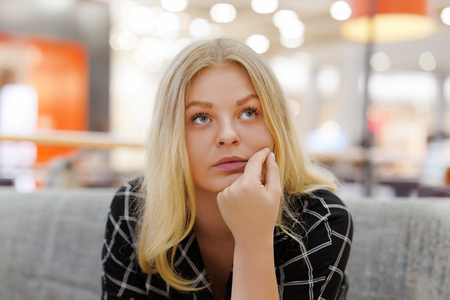 Lonely young girl is sad. Portrait of a beautiful sad girl close-up. Woman feel depression.の写真素材