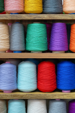 Set of colored threads for sewing on coils. Pile of big colorful spools of thread. Colored thread spools of thread large class, textiles, backgroundの写真素材