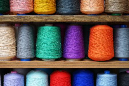 Set of colored threads for sewing on coils. Pile of big colorful spools of thread. Colored thread spools of thread large class, textiles, backgroundの写真素材